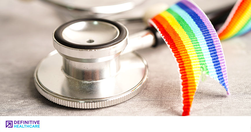 A close-up on a stethoscope decorated with a tiny Pride flag. 