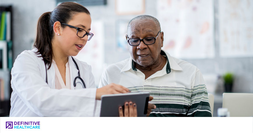 A healthcare professional reviews test results with an elderly patient. 