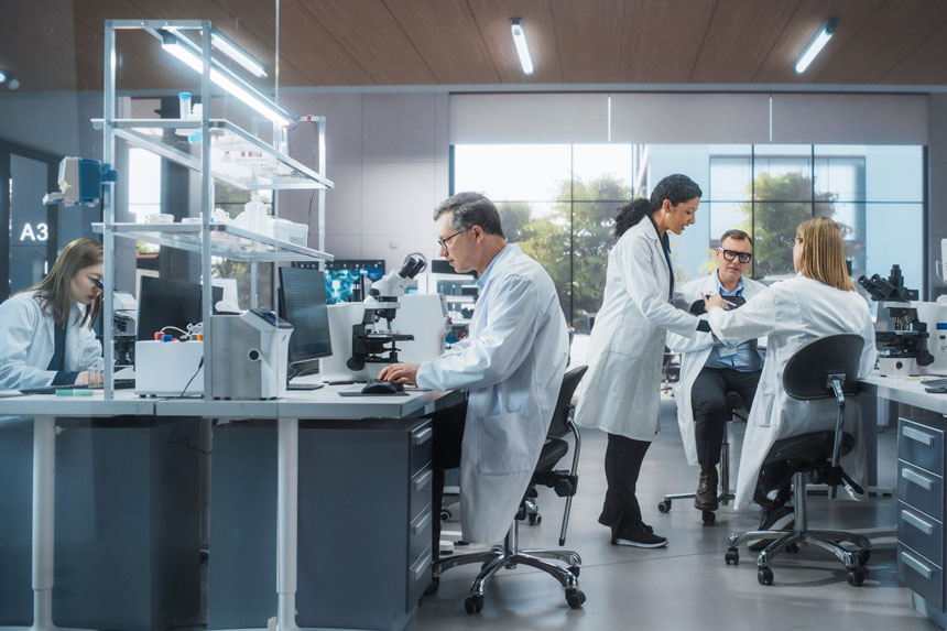 Five healthcare professionals in a laboratory setting.