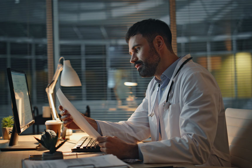 physician working late on clinical documentation