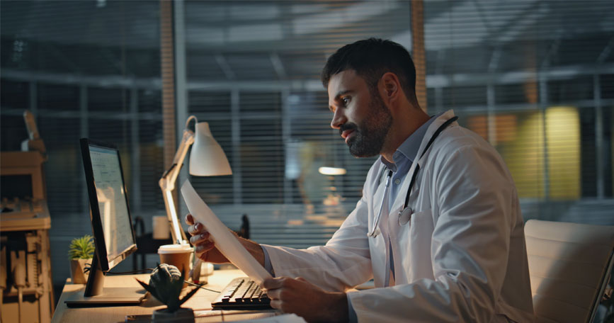physician working late on clinical documentation