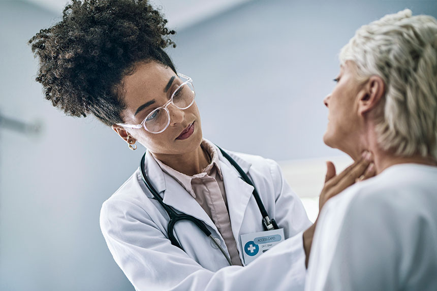 A female doctor examines an elderly female patient. 