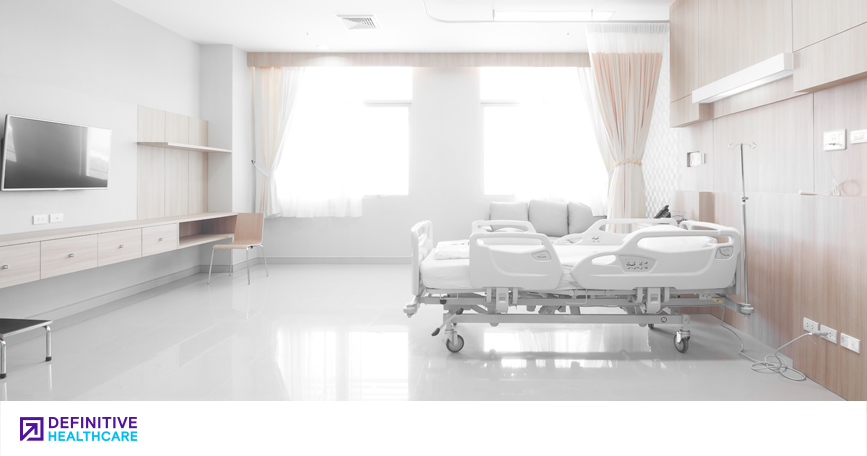 A white bright hospital room with a hospital bed in it