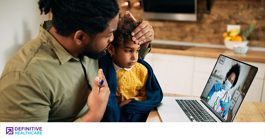 Parent and child speaking with a doctor through a computer